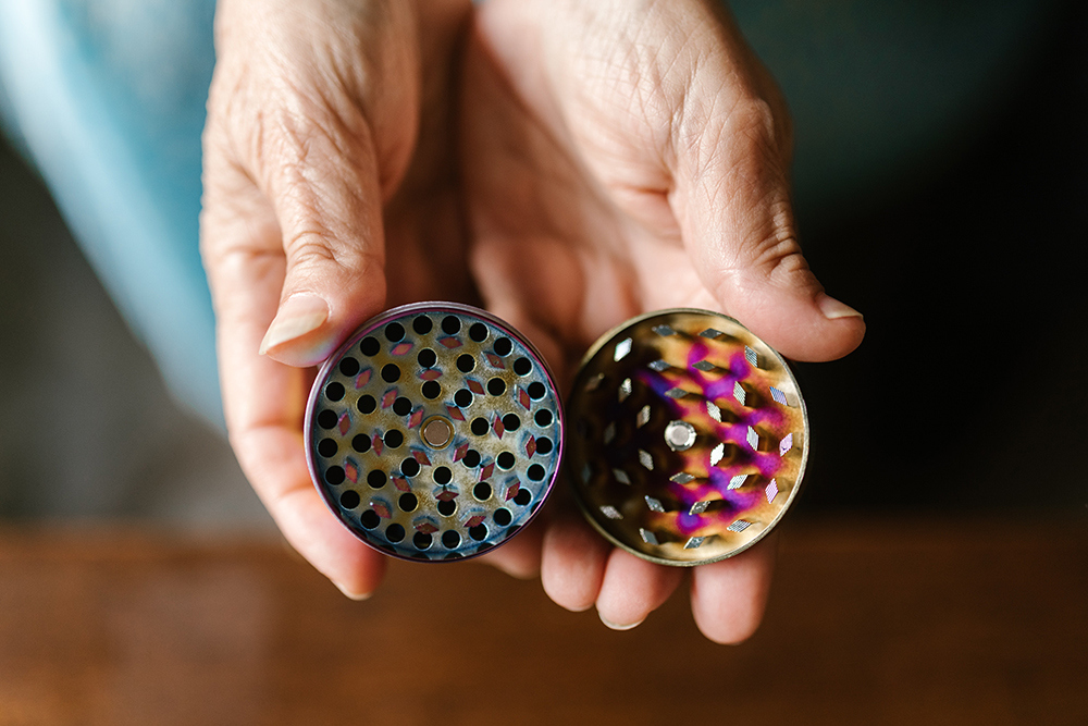 person hold a grinder which is a great gift for cannabis users